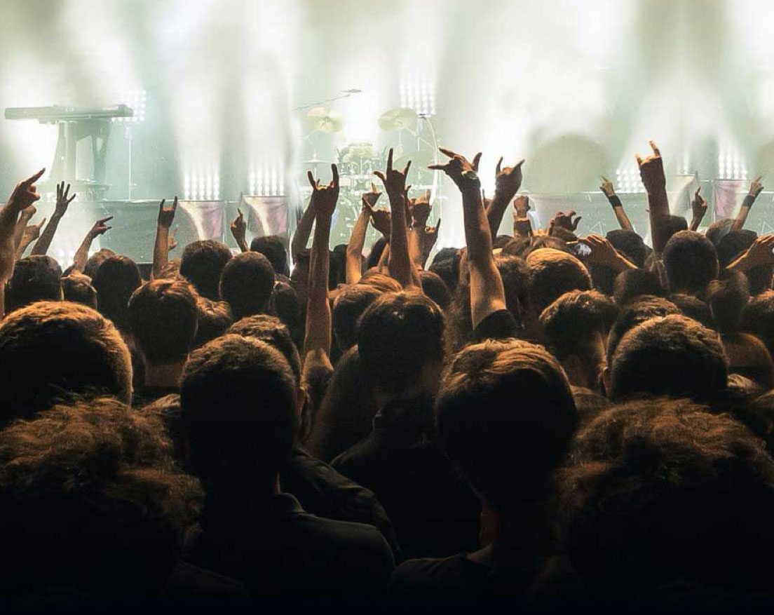 Crowd at a gig with their hands in the air