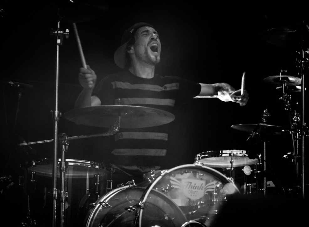 Drummer playing a drum kit