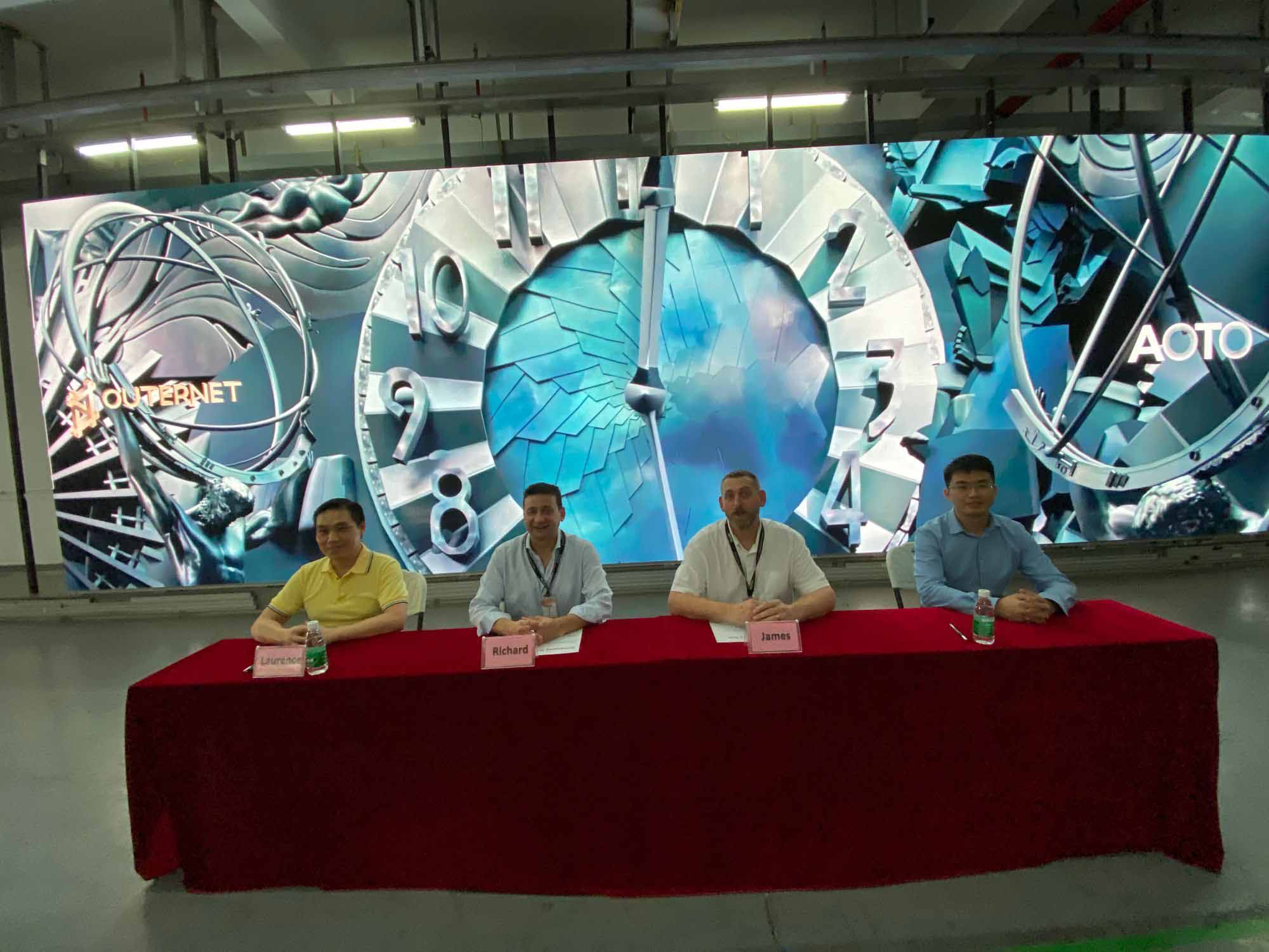 Representatives from Outernet and AOTO sitting at the table